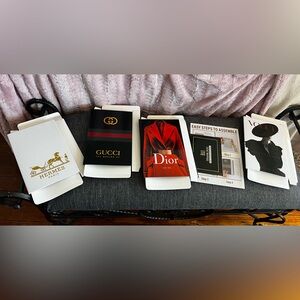 Set of four decorative faux luxury books. Dior, Hermes, Vogue and Gucci.